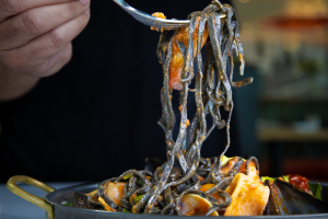 fork holding squid ink pasta from Taverna Toscana